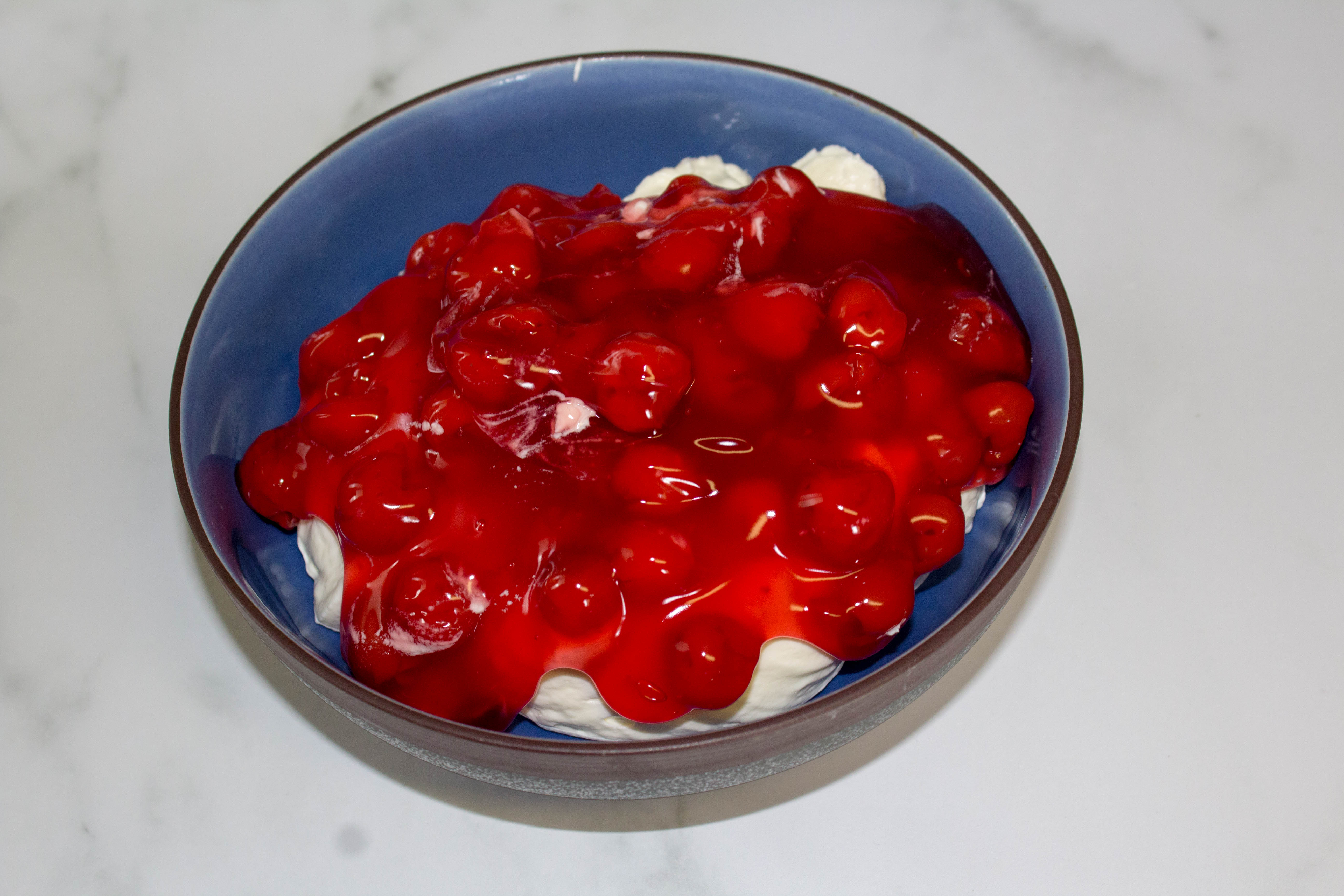 Cherry Cheesecake dip in a blue bowl.
