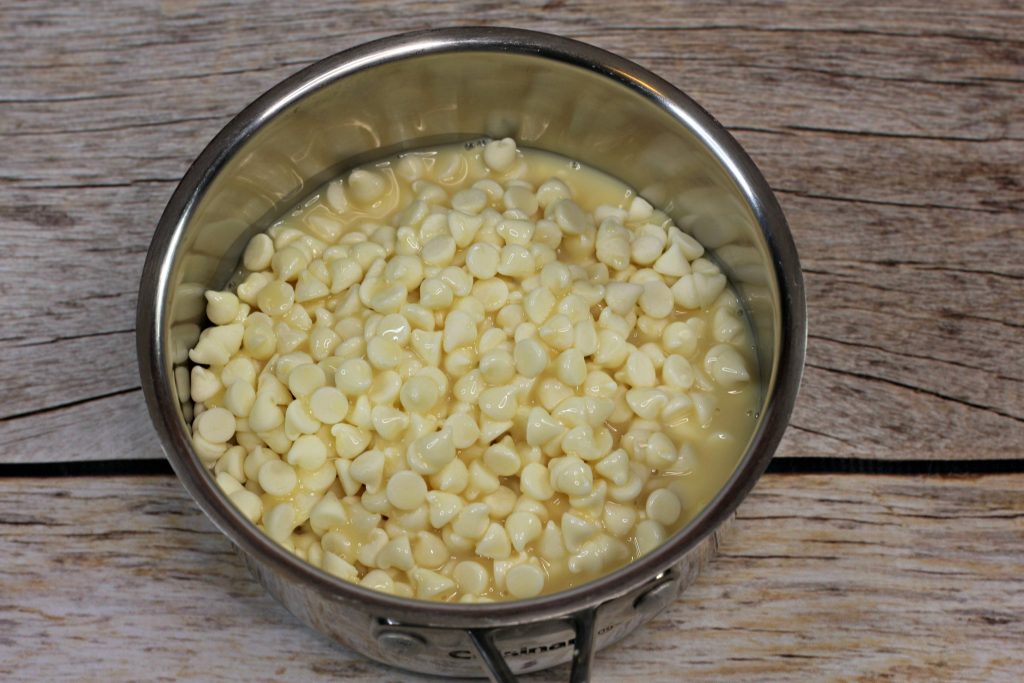 white chocolate chips and condensed milk in a bowl
