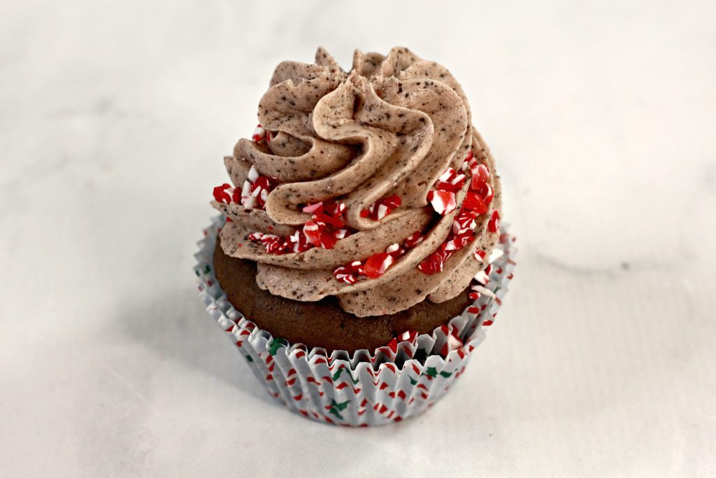 Oreo cupcakes with chocolate frosting and candy cane pieces