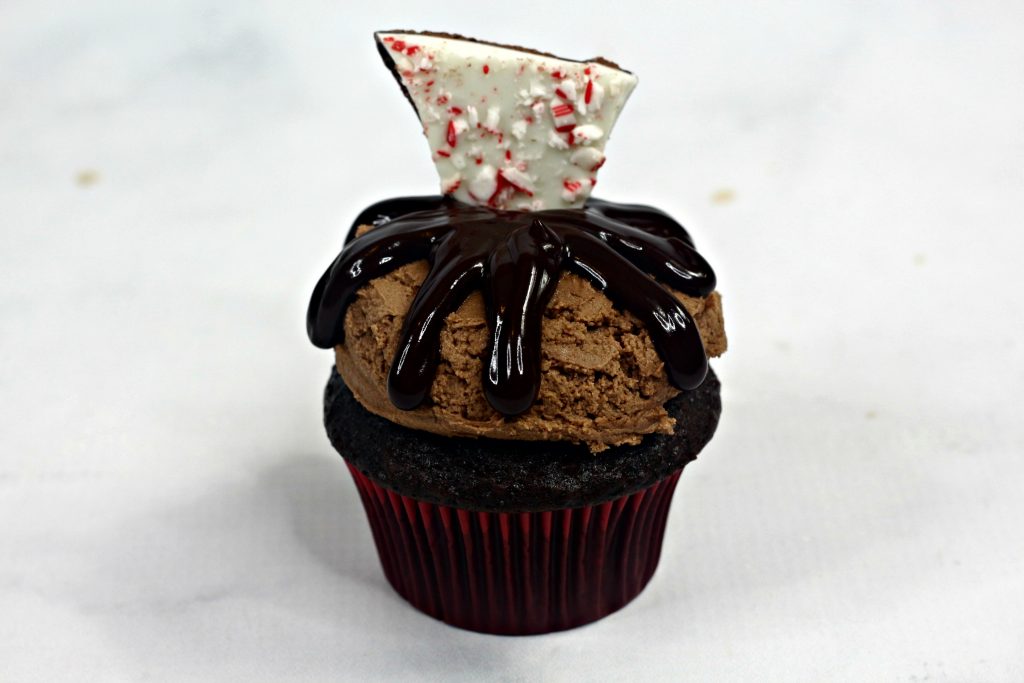 chocolate cupcake with chocolate frosting topped with pepperming bark