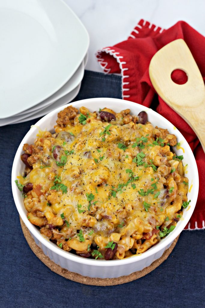 pasta, cheese and chili in a white bowl