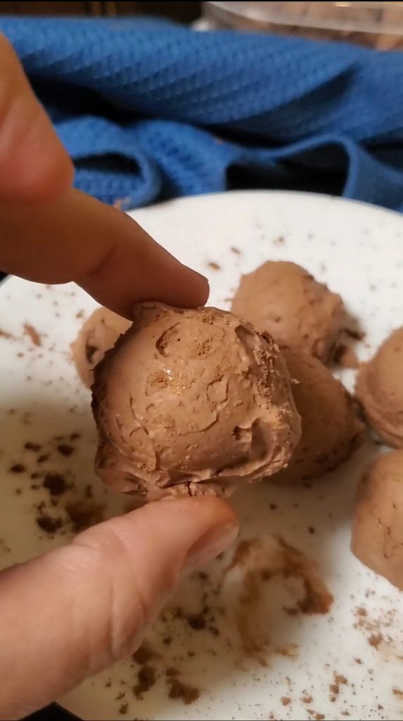 hand holding chocolate cheesecake fat bombs