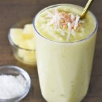 The Pineapple Avocado Smoothie with ingredients on the side.