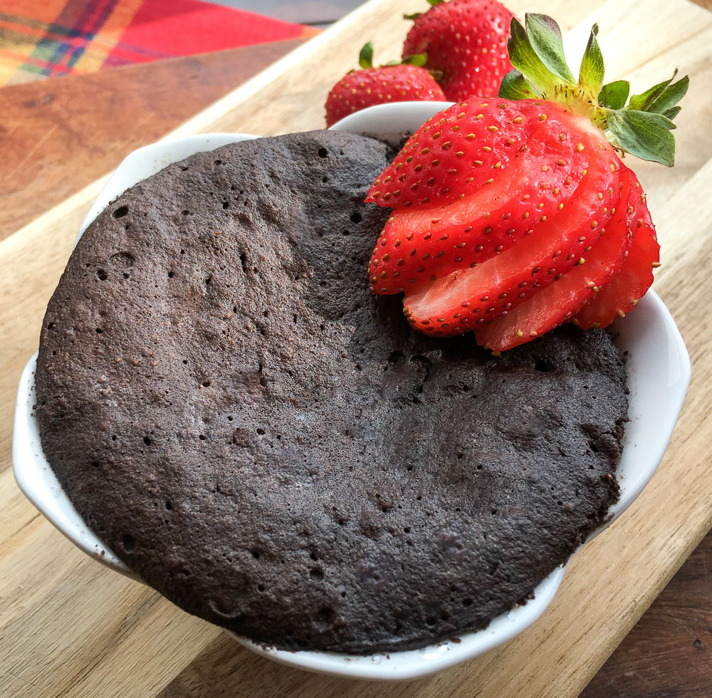 Chocolate Mug Cake with fresh strawberries.