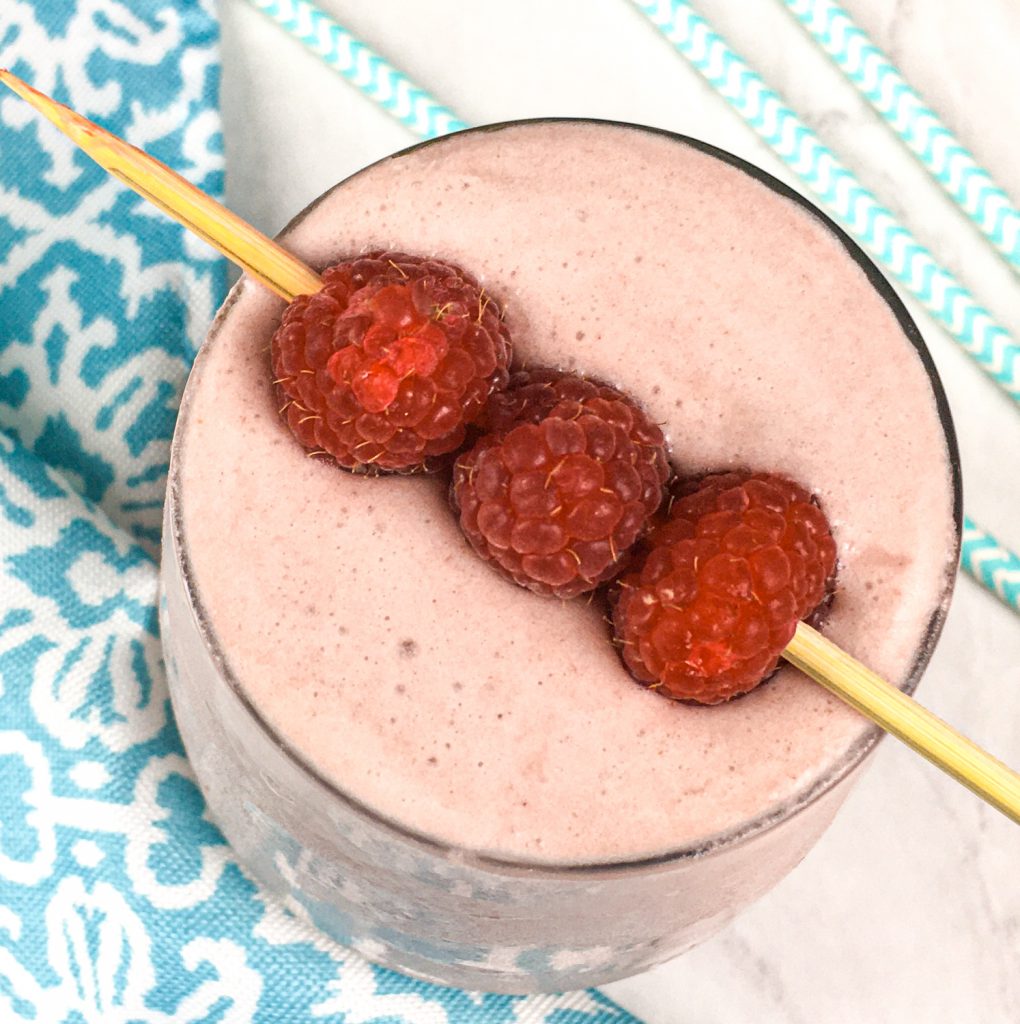 Raspberry Creamsicle Smoothie topped with fresh raspberries.