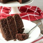 A piece of cake that uses chocolate buttercream frosting.