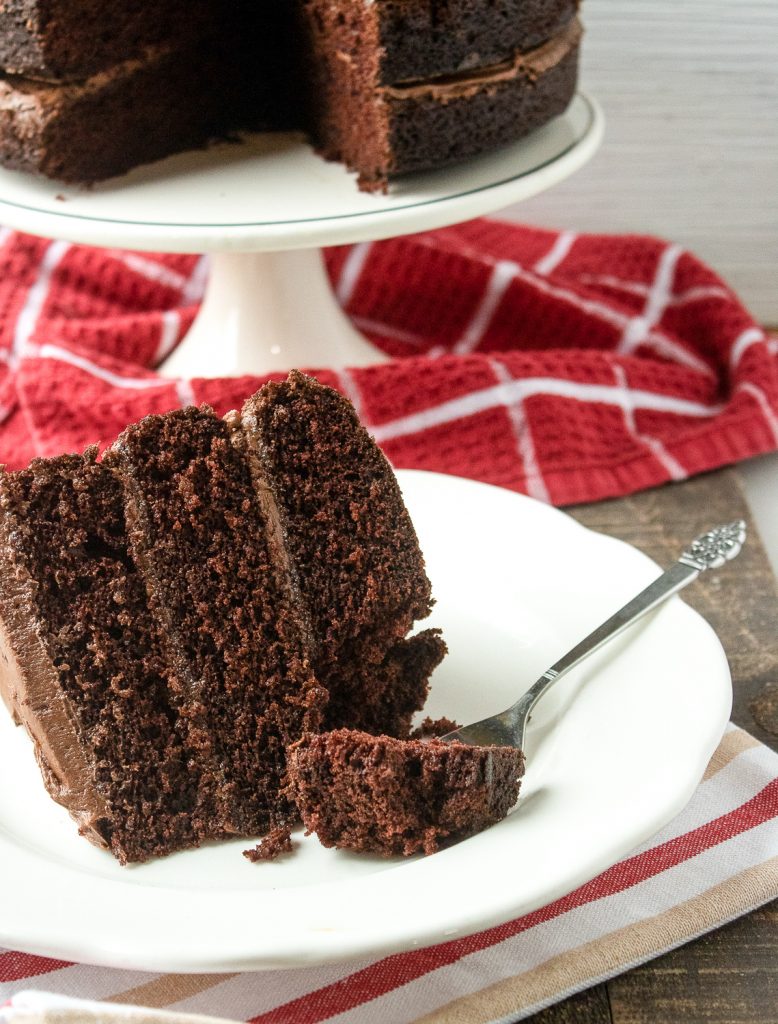 A piece of cake that uses chocolate buttercream frosting. 