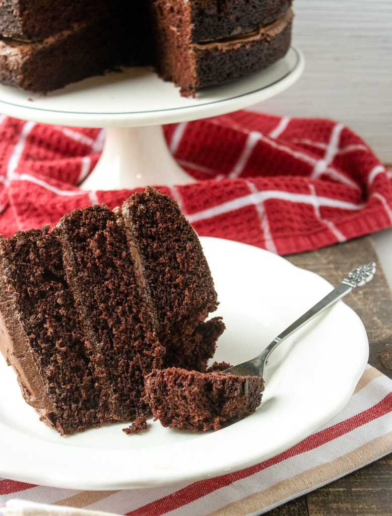 A piece of cake that uses chocolate buttercream frosting.