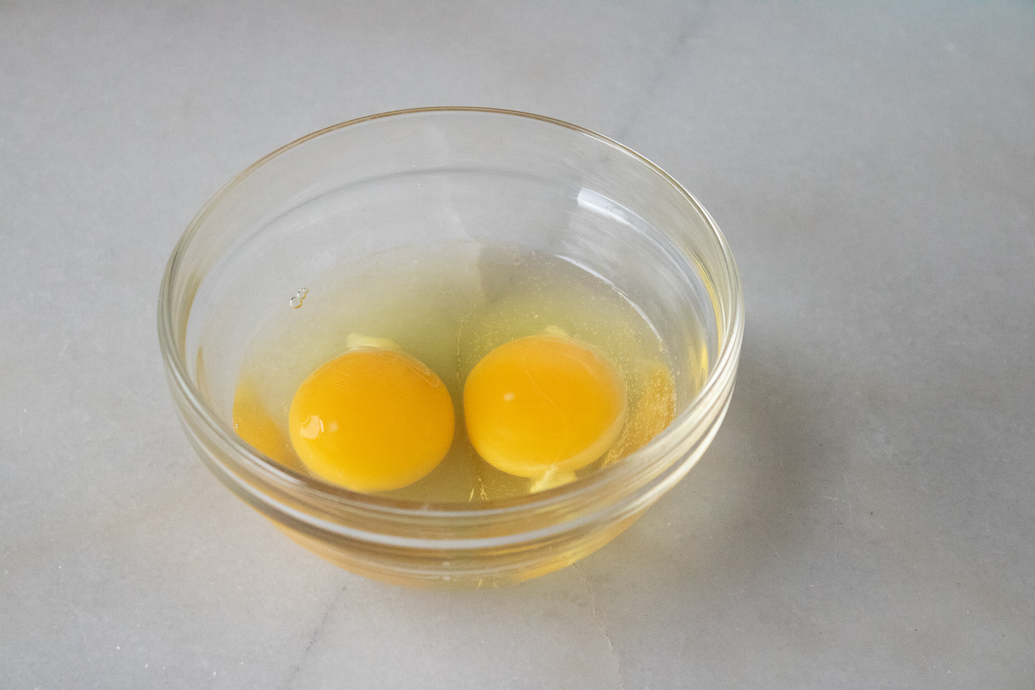 The whole eggs in a glass bowl.