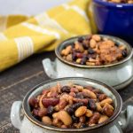 Slow Cooker Baked Beans on a wooden table.