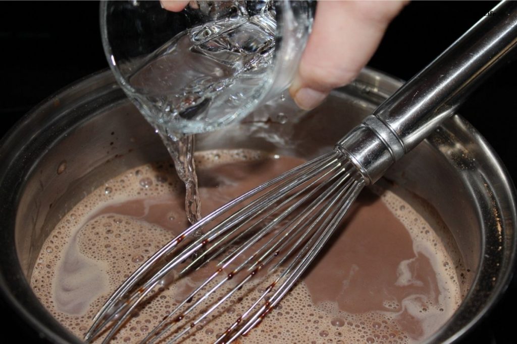 Adding the water into the chocolate mixture.