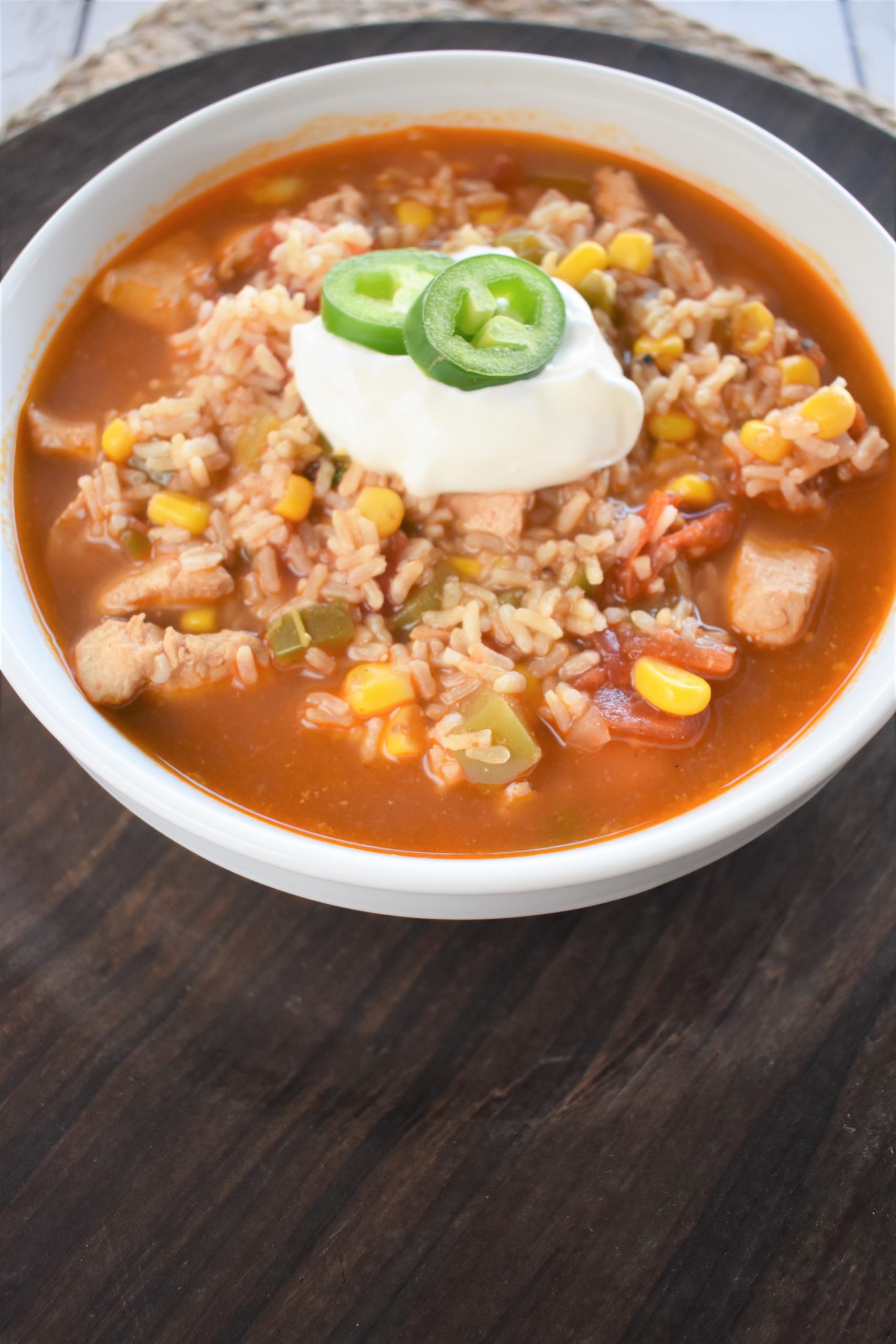 Slow Cooker Southwest Chicken Rice Soup topped with sour cream.