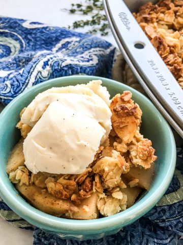 Apple Crisp in a blue bowl.